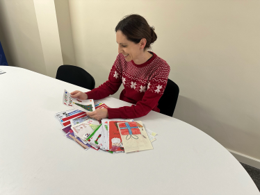 Aphra Brandreth deciding the winner of her 2024 Christmas Card Competition